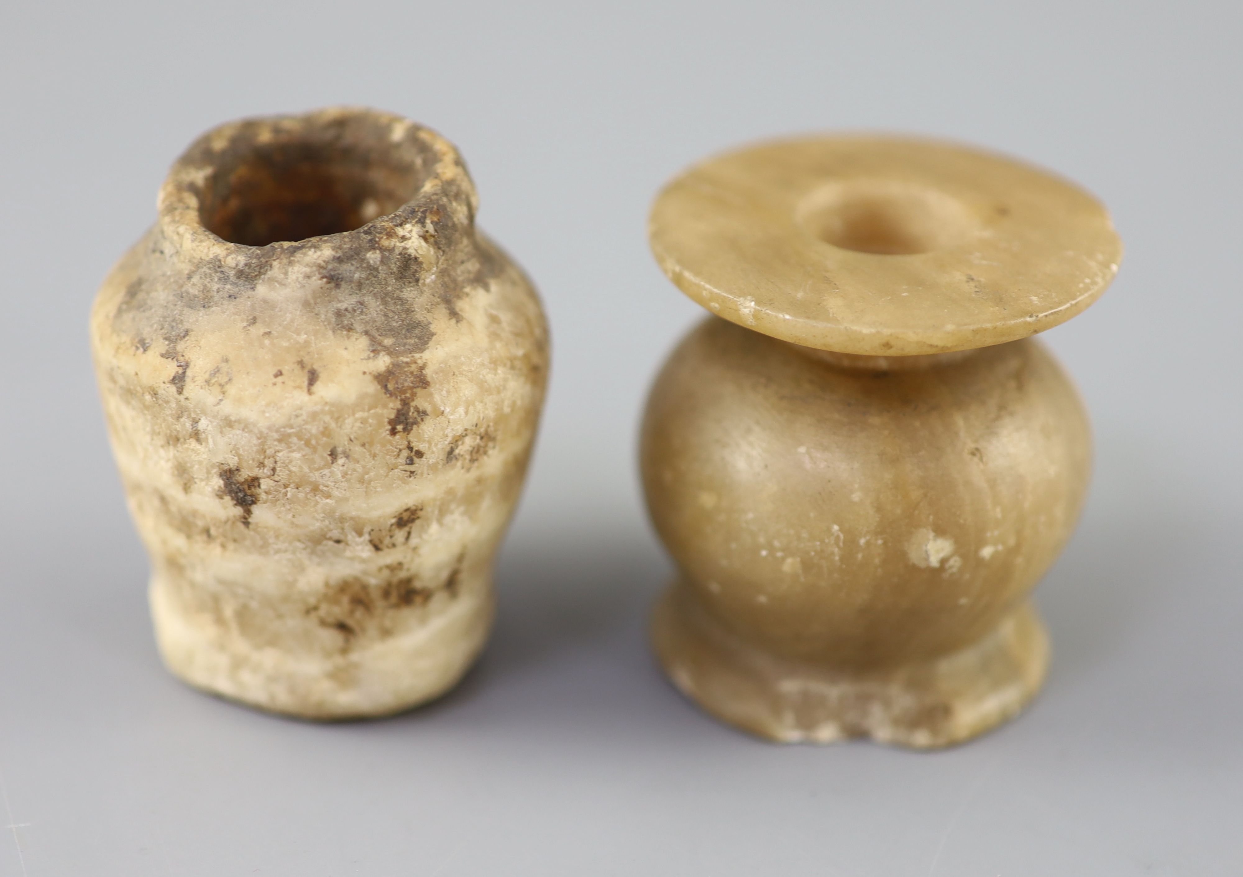 Two Egyptian alabaster cosmetic jars, c.1500 BC and Ptolemaic period (305-30 BC), Provenance - A. T. Arber-Cooke